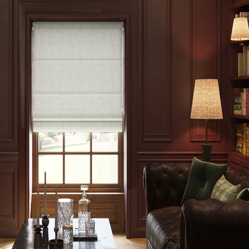 Elegant living room with a dark red wall, a leather sofa, and a window covered with a light gray Roman shade