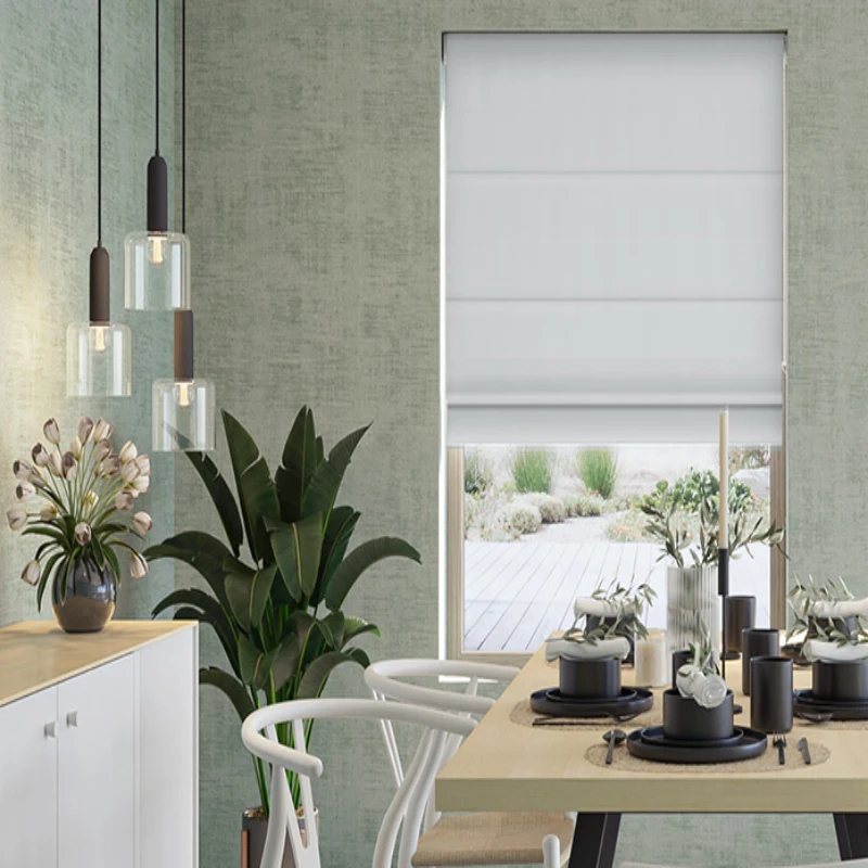 a green wall, a dining table, and a window covered with a white Roman shade