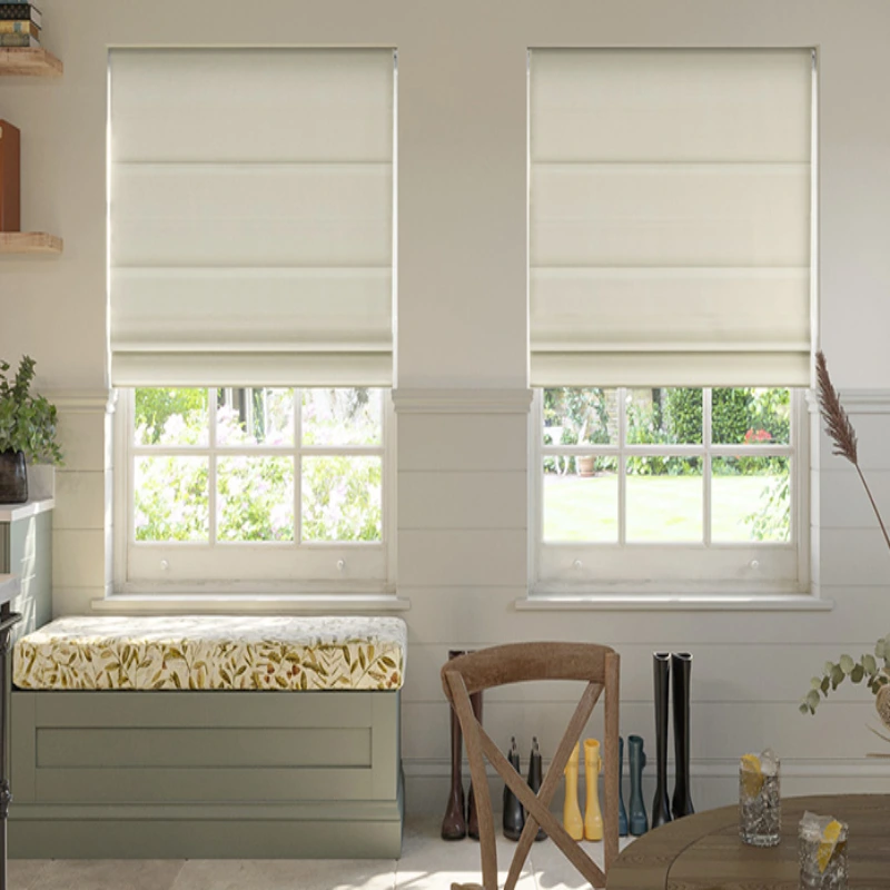 area, two windows covered with white Roman shades, and a view of a garden outside