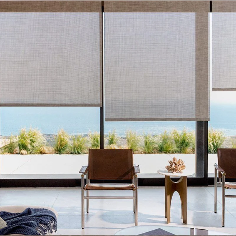 Elegant window treatment with teal roller blind in a neutral-toned room.