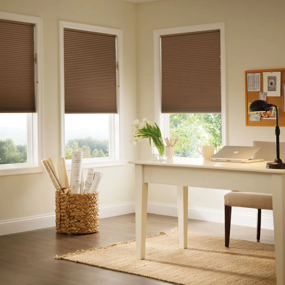 Stylish home office interior with natural light filtered through brown blinds